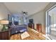 Spacious bedroom with hardwood floors and a sliding glass door leading to the lanai at 13719 Artesa Bell Dr, Riverview, FL 33579