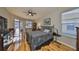Bedroom with hardwood floors, natural light, and a sliding door to the screened patio at 13719 Artesa Bell Dr, Riverview, FL 33579