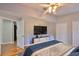 Cozy bedroom with warm wood floors, a large TV, and ample closet space for comfortable living at 13719 Artesa Bell Dr, Riverview, FL 33579