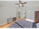 Comfortable bedroom featuring hardwood floors, ceiling fan, and easy access to the bathroom and closet space at 13719 Artesa Bell Dr, Riverview, FL 33579