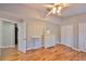 Bedroom with ceiling fan, hardwood floors, and double door closet at 13719 Artesa Bell Dr, Riverview, FL 33579