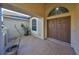 Inviting entryway featuring double doors, a brick-paved patio, and tasteful landscaping for a warm welcome at 13719 Artesa Bell Dr, Riverview, FL 33579