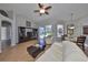 Inviting living room with tile flooring, a ceiling fan, and comfortable seating, perfect for relaxation and entertaining at 13719 Artesa Bell Dr, Riverview, FL 33579