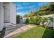 Landscaped backyard area featuring stone tile, pea gravel and mature plantings against a perimeter wall at 145 16Th Ne Ave, St Petersburg, FL 33704