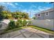 Landscaped backyard area featuring stone tile, pea gravel and mature plantings against a perimeter wall at 145 16Th Ne Ave, St Petersburg, FL 33704