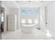 Bright bathroom boasts a freestanding tub with tile floors and three large windows at 145 16Th Ne Ave, St Petersburg, FL 33704