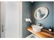 Stylish bathroom featuring a wood countertop, vessel sink, round mirror, and neutral gray walls at 145 16Th Ne Ave, St Petersburg, FL 33704