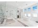 Bright bathroom features a soaking tub, frameless shower, dual sinks, and three windows at 145 16Th Ne Ave, St Petersburg, FL 33704
