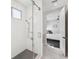 Modern shower stall with glass door and marble tile floor leads to the primary bedroom at 145 16Th Ne Ave, St Petersburg, FL 33704
