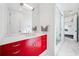 A bright, modern bathroom featuring a red cabinet under the sink and a walk-in shower at 145 16Th Ne Ave, St Petersburg, FL 33704