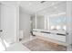 Bright bathroom features a double sink vanity with a large mirror and tile flooring at 145 16Th Ne Ave, St Petersburg, FL 33704