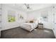This bedroom features a ceiling fan, gray carpet, and windows for natural light at 145 16Th Ne Ave, St Petersburg, FL 33704