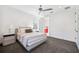 This bedroom features a ceiling fan, gray carpet, and an ensuite bathroom with red cabinets at 145 16Th Ne Ave, St Petersburg, FL 33704