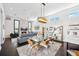 Open concept dining room featuring modern lighting, glass table and decor shelving at 145 16Th Ne Ave, St Petersburg, FL 33704