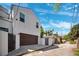 Exterior of two-story home featuring a brown two-car garage and gated entrance in an alley at 145 16Th Ne Ave, St Petersburg, FL 33704