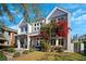 Stunning two-story modern home with red bougainvillea, fresh landscaping, and a light-filled facade at 145 16Th Ne Ave, St Petersburg, FL 33704