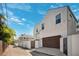Exterior of two-story home featuring a brown two-car garage and gated entrance in an alley at 145 16Th Ne Ave, St Petersburg, FL 33704