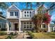 Striking two-story modern home with a covered front porch, lovely landscaping, and beautiful flowering vines at 145 16Th Ne Ave, St Petersburg, FL 33704