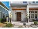 Elegant entrance with a modern pergola, natural wood accents, and manicured landscaping at 145 16Th Ne Ave, St Petersburg, FL 33704