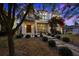 Stunning front exterior of home with bougainvillea and landscaped walkway at twilight at 145 16Th Ne Ave, St Petersburg, FL 33704