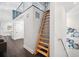 Hallway featuring sleek wood floors, modern art, and access to the home's second story via a wooden ladder at 145 16Th Ne Ave, St Petersburg, FL 33704