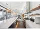 Spacious kitchen with modern appliances, large island, and dark hardwood floors leading to the living area at 145 16Th Ne Ave, St Petersburg, FL 33704