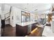Bright, open kitchen with an island featuring a sink and stainless appliances flowing into the living space at 145 16Th Ne Ave, St Petersburg, FL 33704