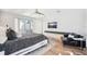 Modern main bedroom with private balcony access, ceiling fan, hardwood floors, and television at 145 16Th Ne Ave, St Petersburg, FL 33704