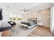 Spacious main bedroom with whitewashed brick accent wall, wood floors, and abundant natural light at 145 16Th Ne Ave, St Petersburg, FL 33704