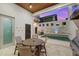 A covered outdoor space with dining table overlooking the pool at 145 16Th Ne Ave, St Petersburg, FL 33704