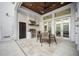Outdoor kitchen featuring stainless steel grill, wood ceiling, travertine flooring, and easy access to the outdoor shower at 145 16Th Ne Ave, St Petersburg, FL 33704