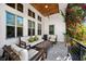 Relaxing covered patio with comfortable seating, wood ceiling, and lush flowering vines for outdoor living at 145 16Th Ne Ave, St Petersburg, FL 33704