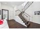 Staircase with dark hardwood floors, stainless steel railings, and natural light, leading to the upper levels at 145 16Th Ne Ave, St Petersburg, FL 33704