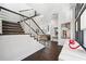 Staircase featuring wood stairs, dark hardwood floors, stainless steel railings, and an open-concept design at 145 16Th Ne Ave, St Petersburg, FL 33704