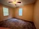 A simple bedroom featuring dual windows with blinds and a ceiling fan at 1502 S Wiggins Rd, Plant City, FL 33566