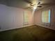 Modest bedroom featuring a ceiling fan and dual windows, offering potential for customization at 1502 S Wiggins Rd, Plant City, FL 33566