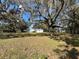 Large, oak-shaded front yard of the one-story home at 1502 S Wiggins Rd, Plant City, FL 33566