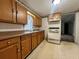 Classic kitchen features wood cabinets, laminate countertops, white appliances and decorative wallpaper at 1502 S Wiggins Rd, Plant City, FL 33566