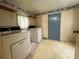 Functional laundry room with washer, dryer, and a bright blue door at 1502 S Wiggins Rd, Plant City, FL 33566