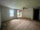 Neutral-toned living room with a ceiling fan and multiple entry points at 1502 S Wiggins Rd, Plant City, FL 33566