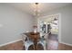 Cozy dining area with modern lighting and a view of the outdoor patio and playhouse at 160 Avon Dr, Safety Harbor, FL 34695