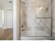 Modern bathroom with a glass shower enclosure and light grey tiling at 16327 Redington Dr, Redington Beach, FL 33708
