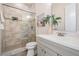 Bright bathroom features a glass enclosed shower and a light gray vanity at 16327 Redington Dr, Redington Beach, FL 33708