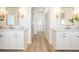 Bright and airy bathroom with dual sinks and vanities separated by walk in shower at 16327 Redington Dr, Redington Beach, FL 33708