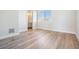 Empty bedroom with wood-look floors, white walls, and a bright window at 16327 Redington Dr, Redington Beach, FL 33708