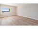 Bright, empty bedroom with hardwood floors and a large window overlooking a bay at 16327 Redington Dr, Redington Beach, FL 33708