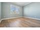Empty bedroom featuring light-blue walls and wood-look flooring at 16327 Redington Dr, Redington Beach, FL 33708
