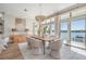 Elegant dining room with waterfront views, featuring modern decor and ample natural light at 16327 Redington Dr, Redington Beach, FL 33708