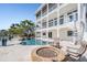 Exterior of a three-story waterfront home with a pool, hot tub, and patio at 16327 Redington Dr, Redington Beach, FL 33708