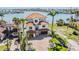 Elegant home with lush landscaping, brick driveway, and a charming tile roof at 16327 Redington Dr, Redington Beach, FL 33708